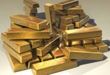 A pile of lustrous gold bars symbolizing wealth and prosperity.